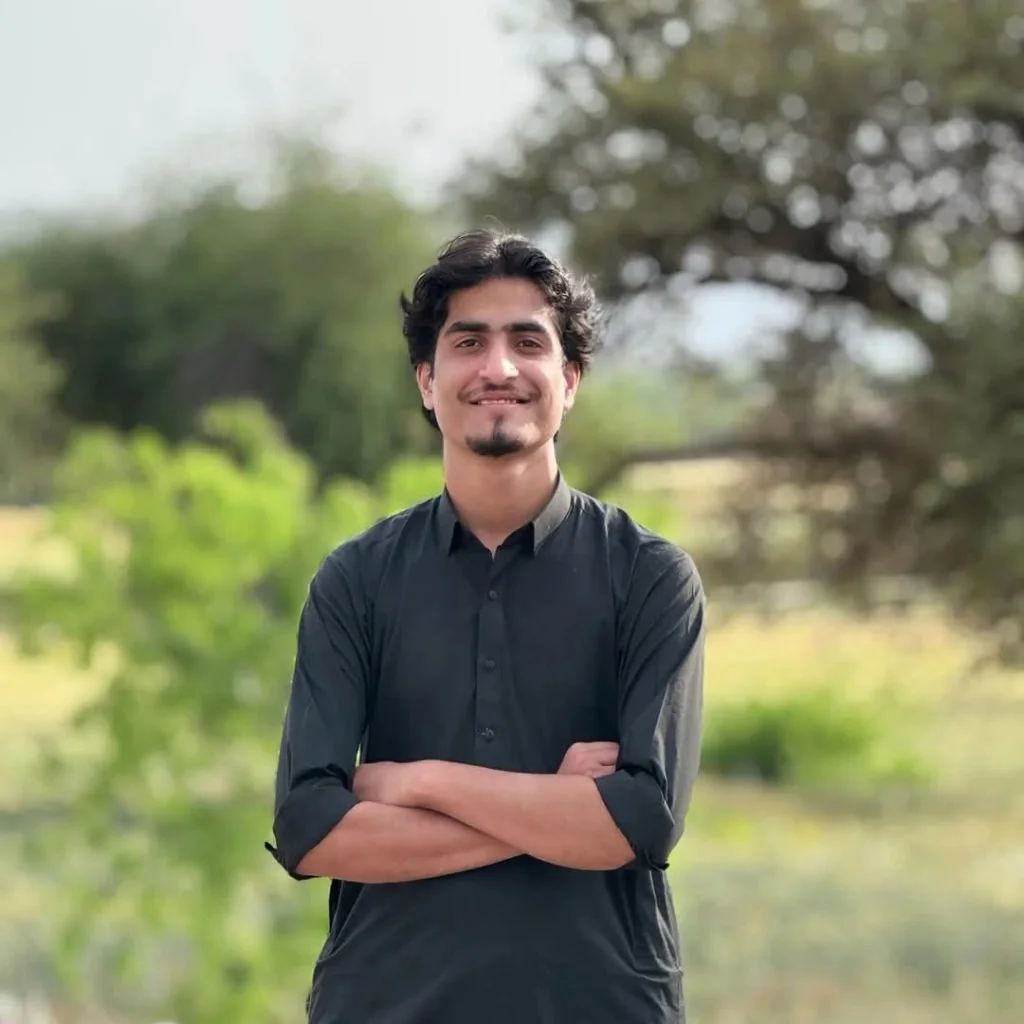 Hamza Ishtiaq standing outdoors with his arms crossed